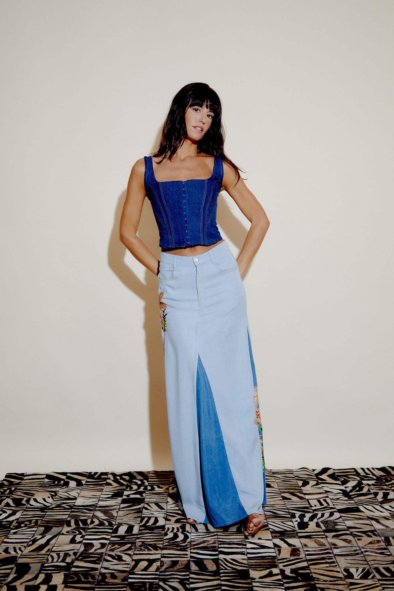 Light blue denim maxi skirt with front slit and embroidered side panel along hem