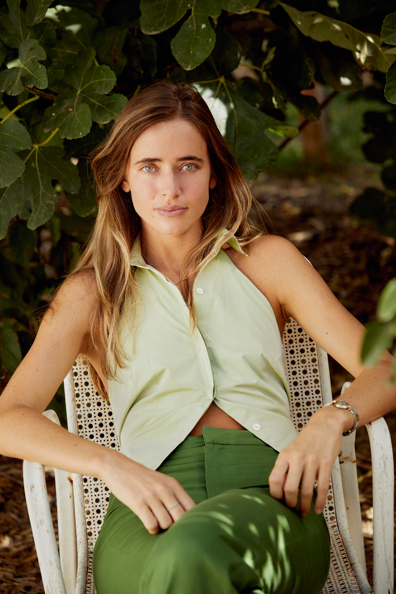 Green sleeveless collared top with button front