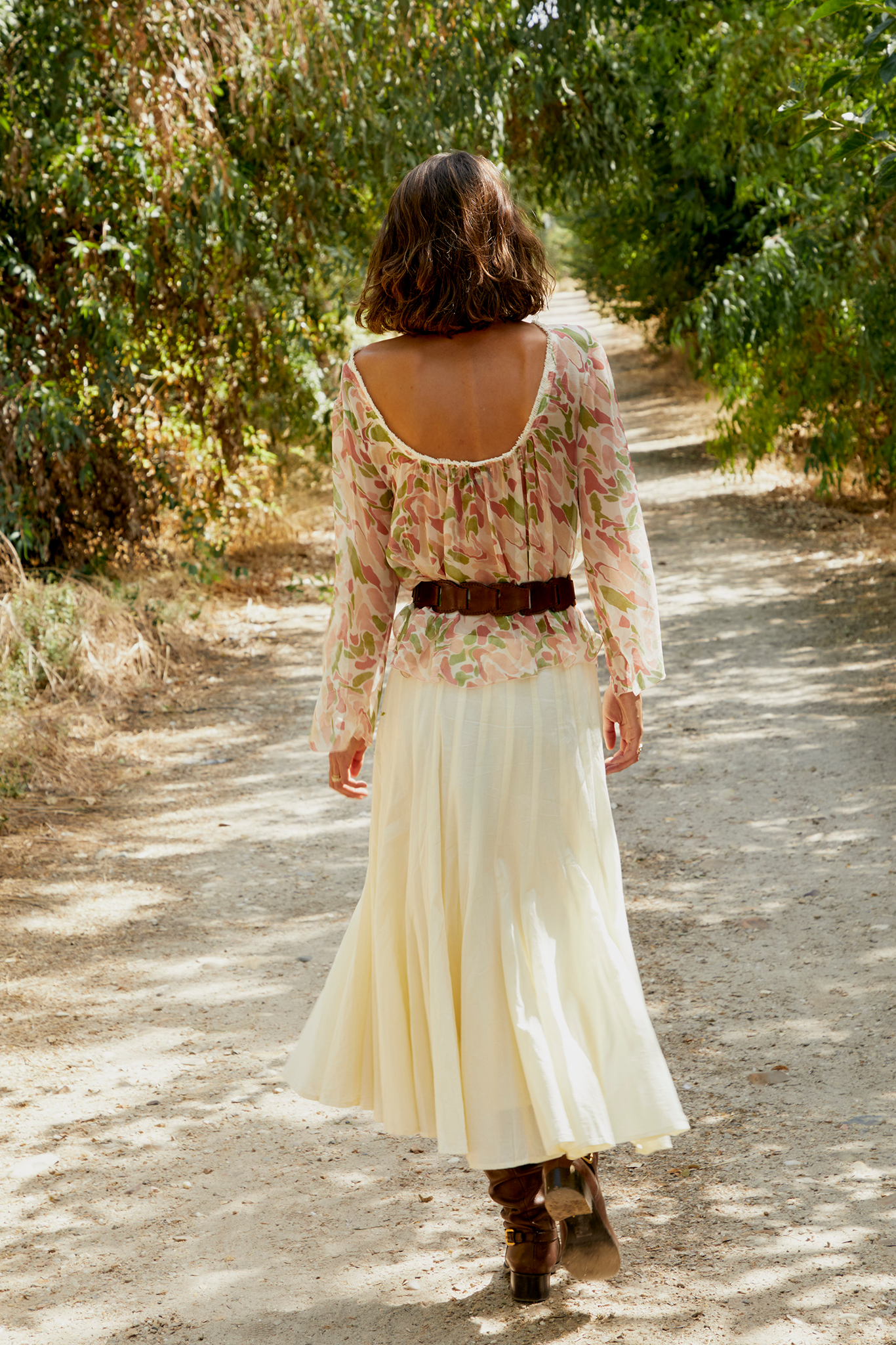 Back view of pastel printed blouse with gathered yoke and wide neckline