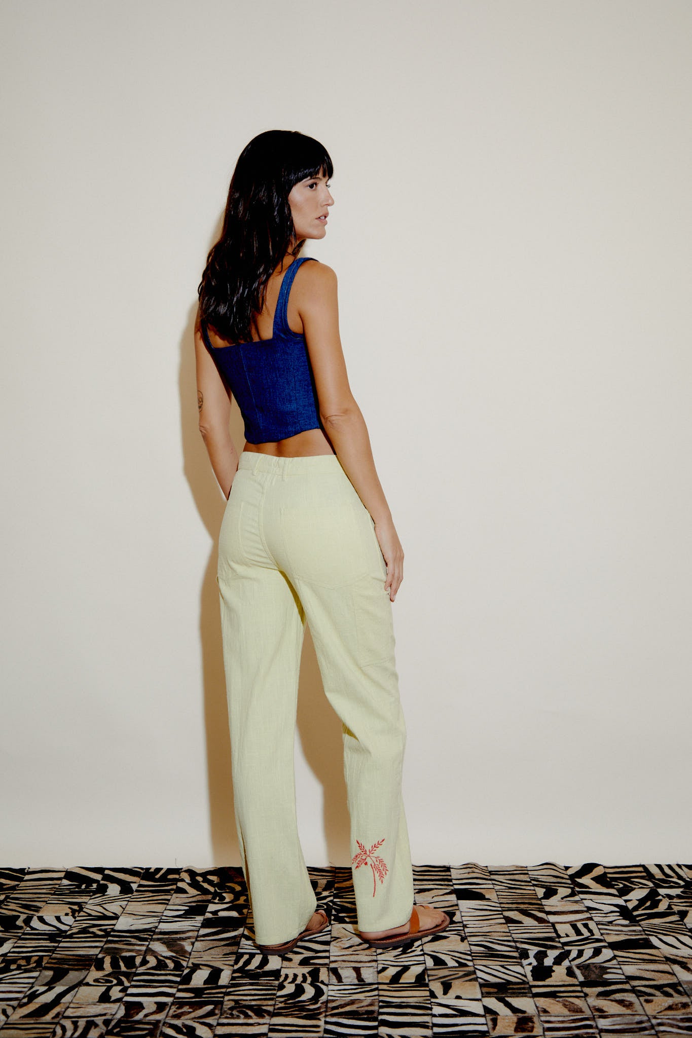 Cecil trousers in light yellow, side view showing relaxed straight-leg silhouette