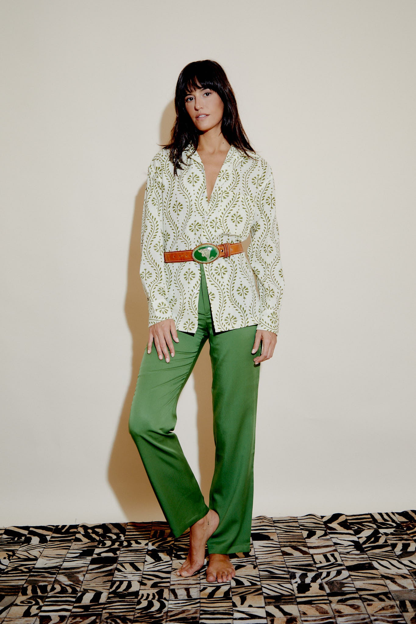 Pistachio green trousers with belt loops and straight legs, front view