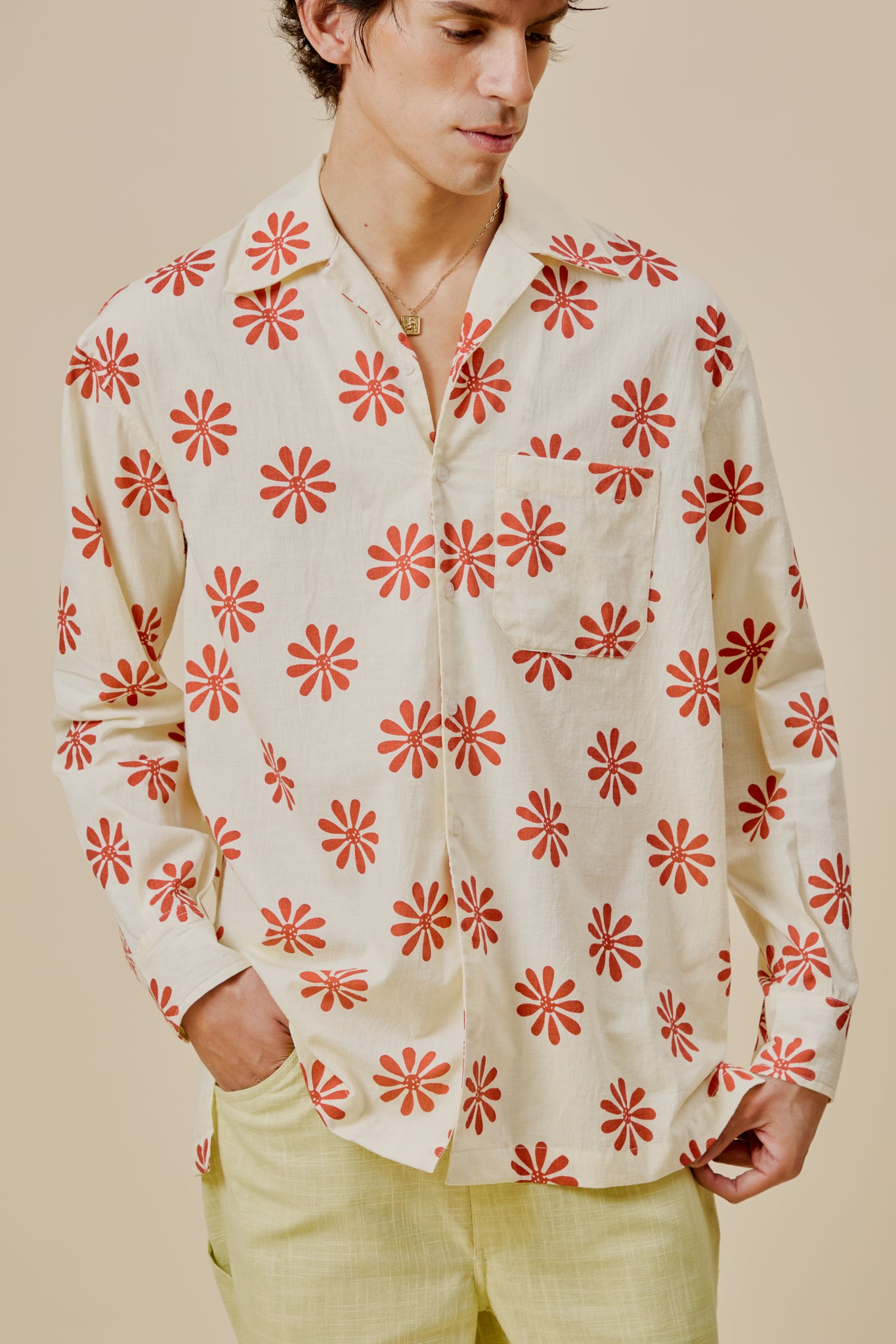 Cream button-up shirt with red flower print, long sleeves and chest patch pocket