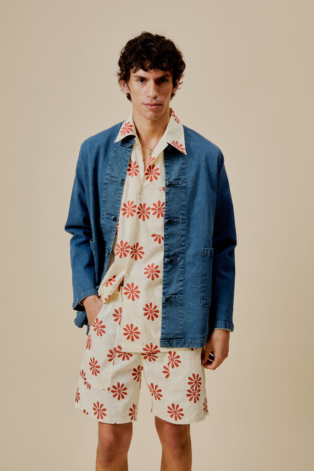 Cream button-up shirt with red flower print, long sleeves and open front placket