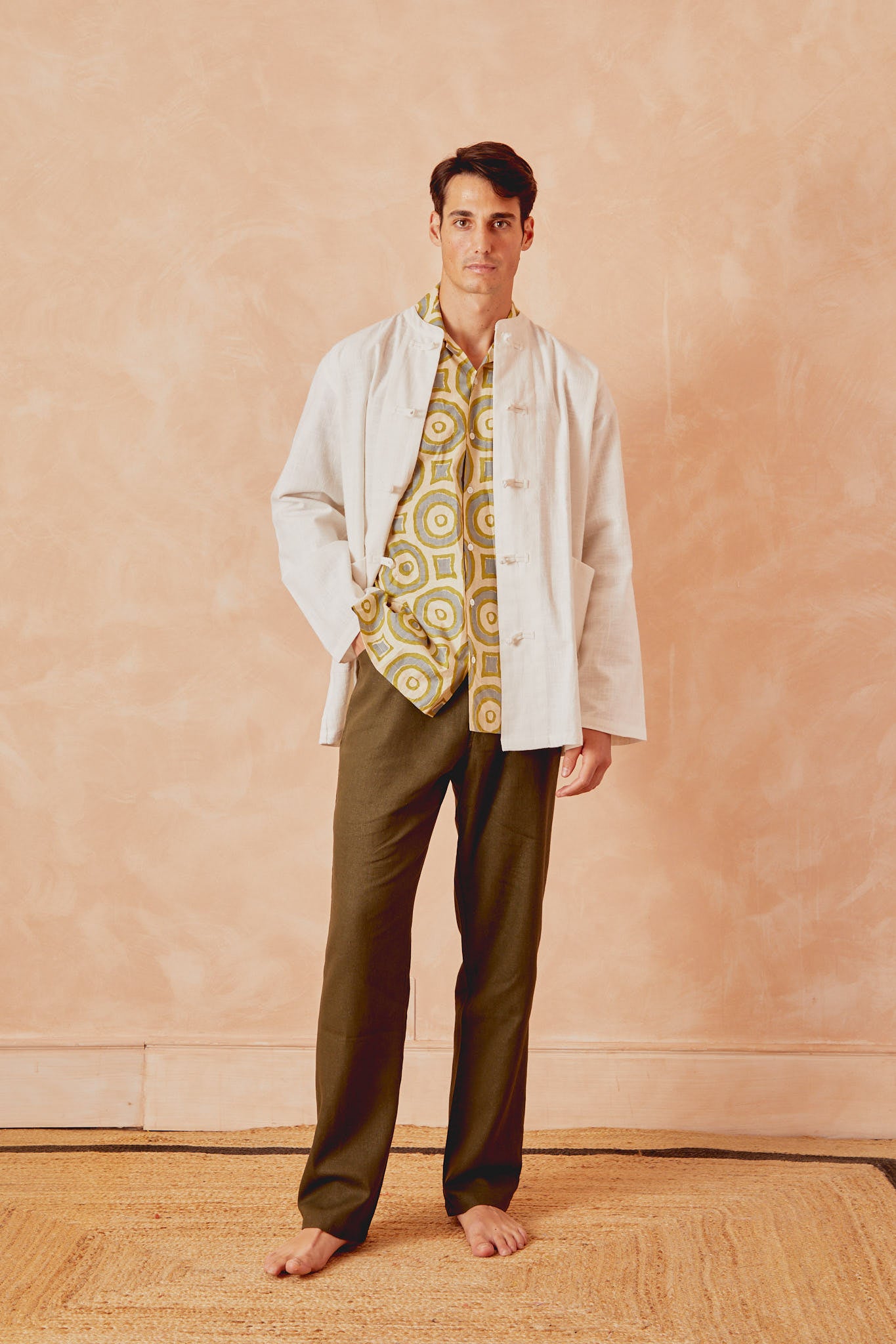 Men's circle-print shirt with button front, cream with green and blue rings, worn open