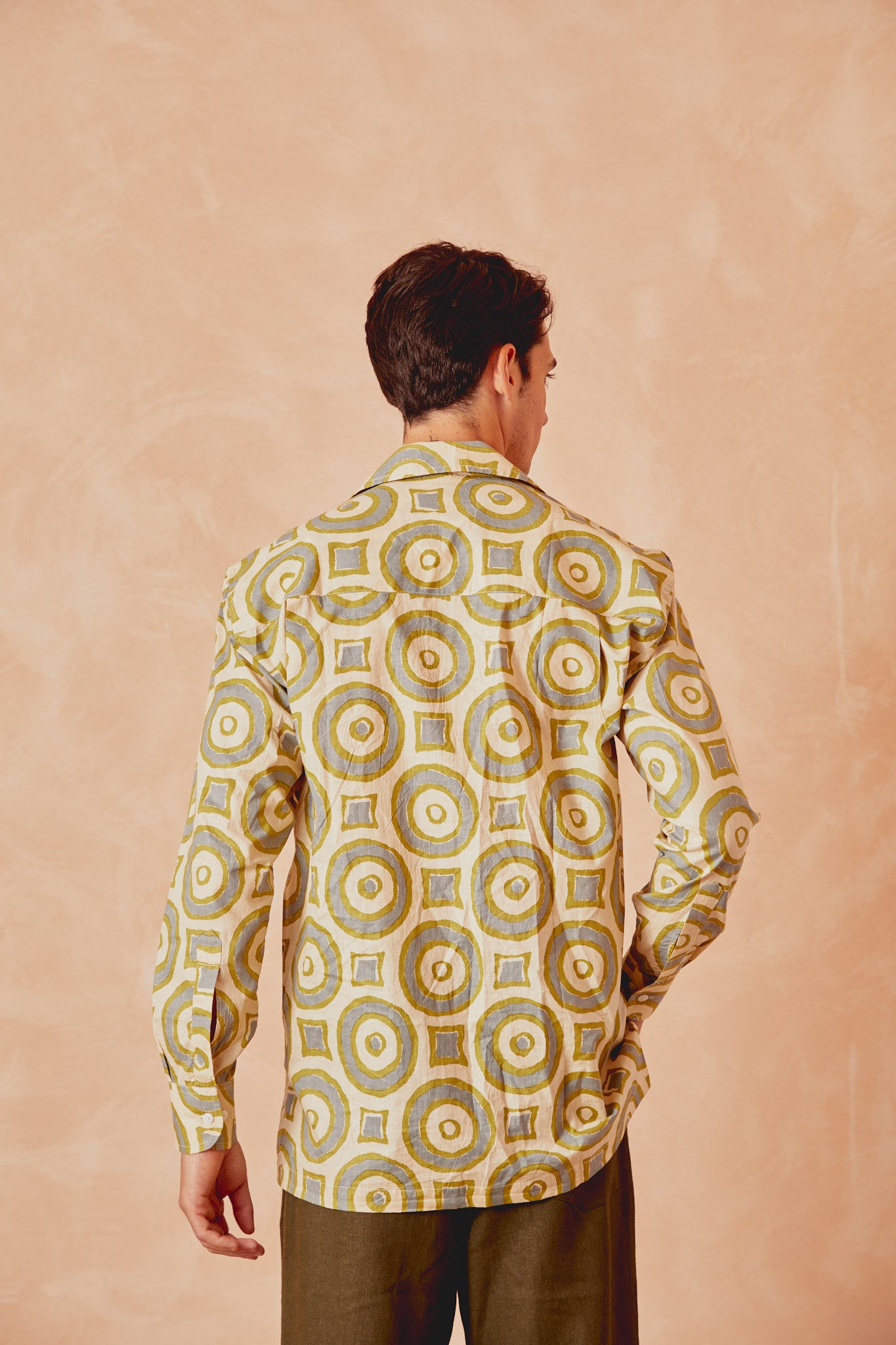 Men's button-up shirt with circle print, back view, cream with green and blue rings