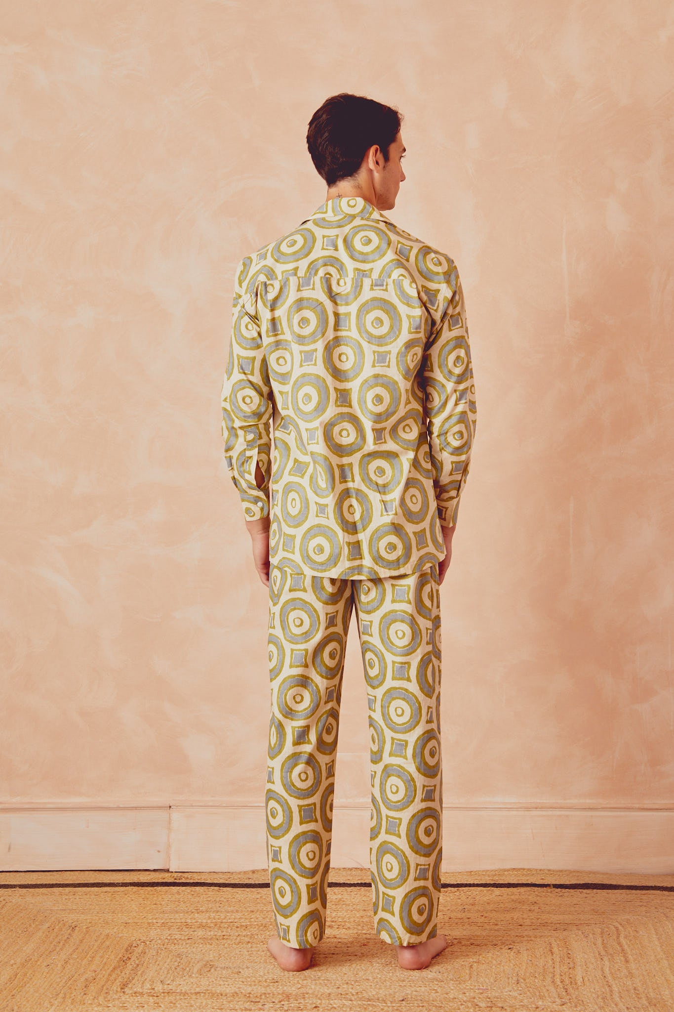 Men's circle-print button-up shirt, back view, cream with green and blue rings, long sleeves