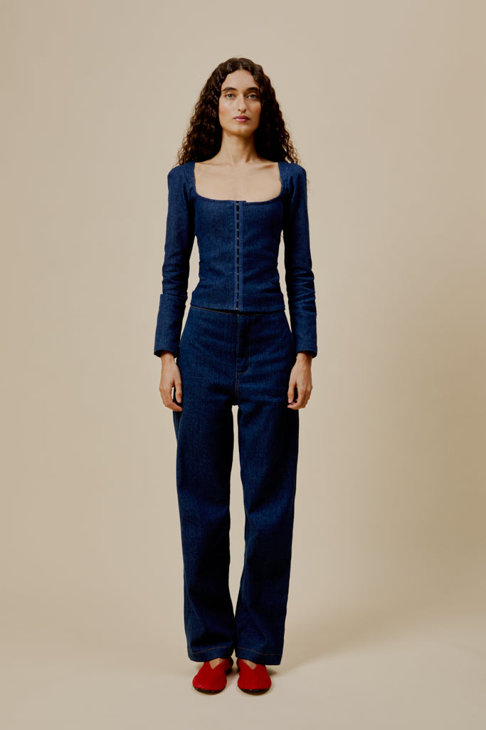 Dark blue denim top with square scoop neckline, long sleeves, and front buttons