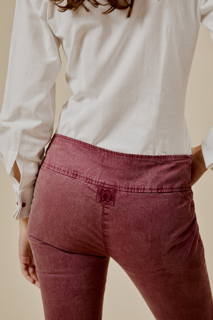 Burgundy trousers with back yoke seam and waistband pocket stitching detail