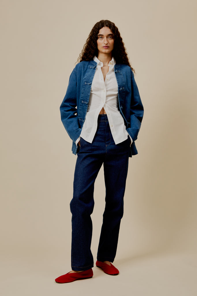 Ralph trousers in dark blue denim, front view with button fly, pockets, and straight leg