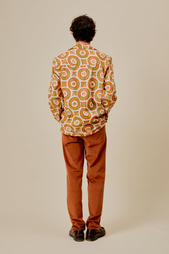 Orange button-up shirt with circular pattern, back view, long sleeves
