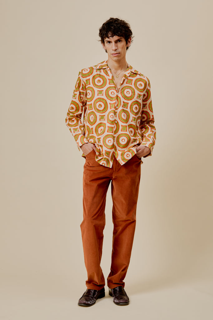 Orange button-up shirt with circular print, front view, long sleeves