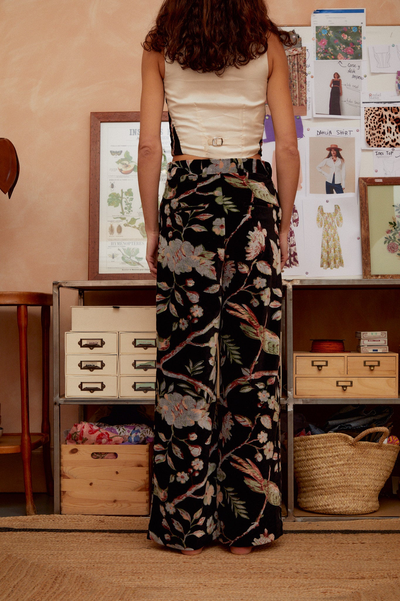 Black floral wide-leg trousers with pink blooms and green leaves, waistband detail