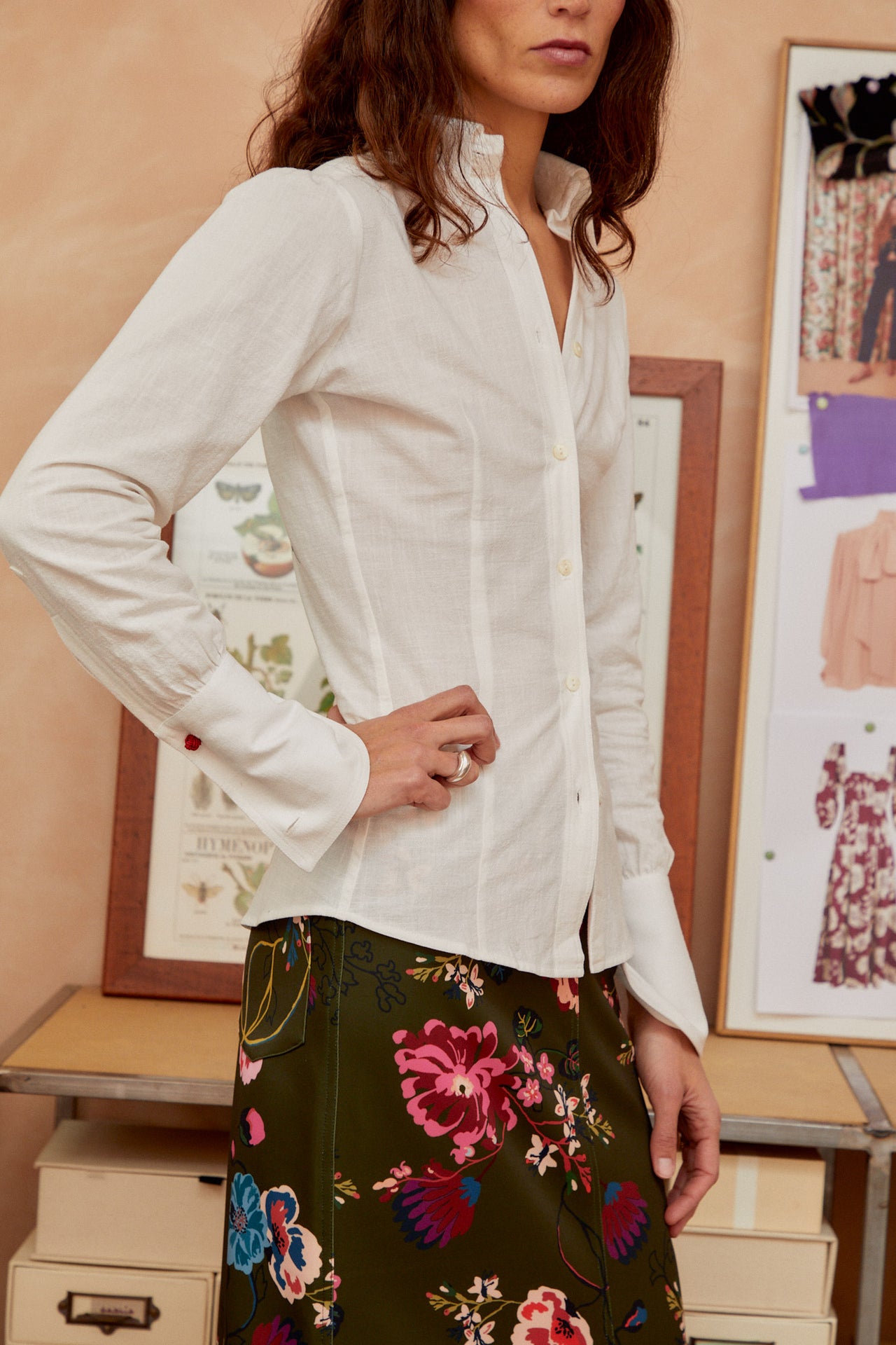 White button-up shirt with spread collar and long gathered sleeves