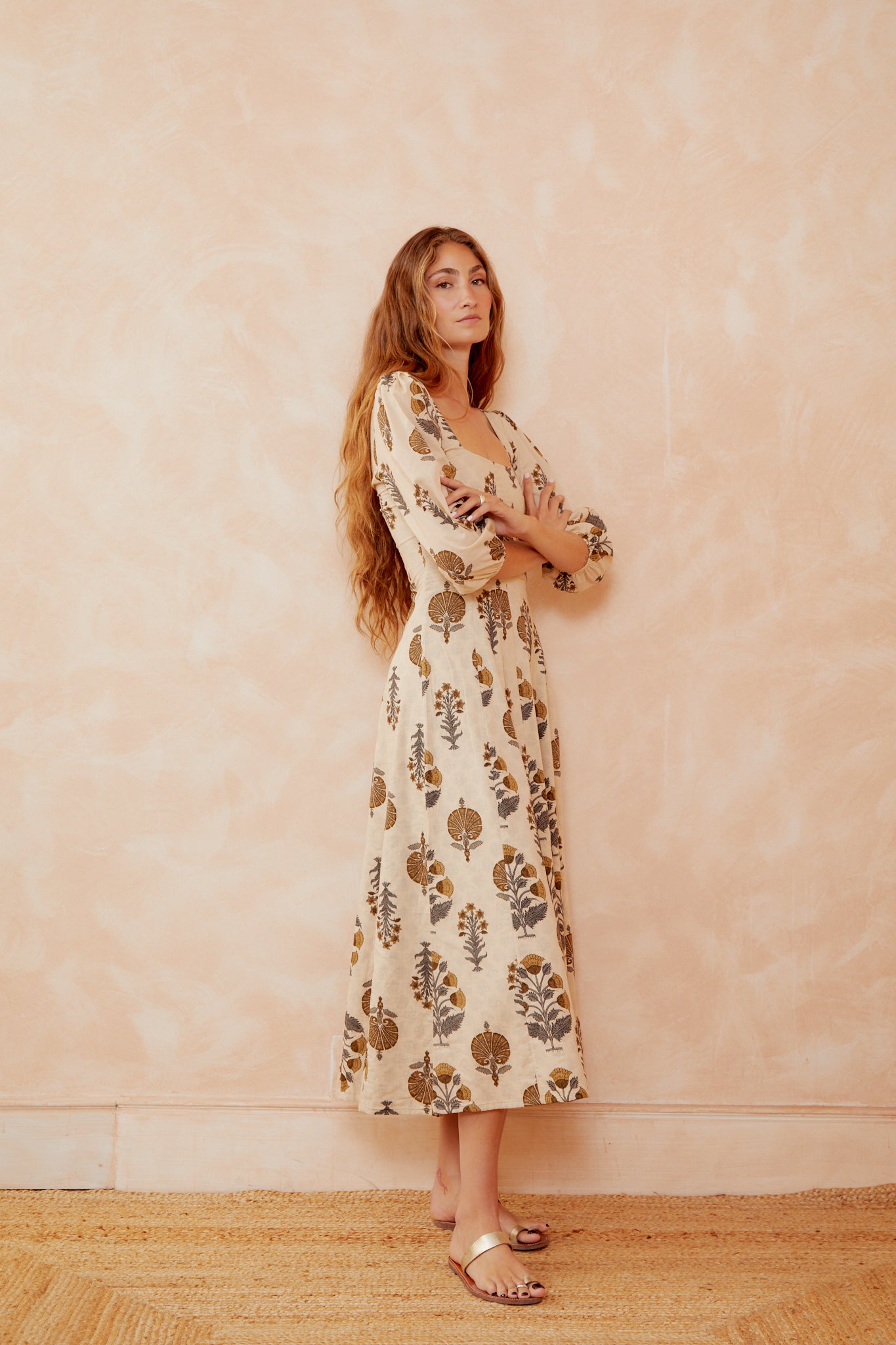 Cream botanical print dress with square neckline and puff sleeves, three-quarter view