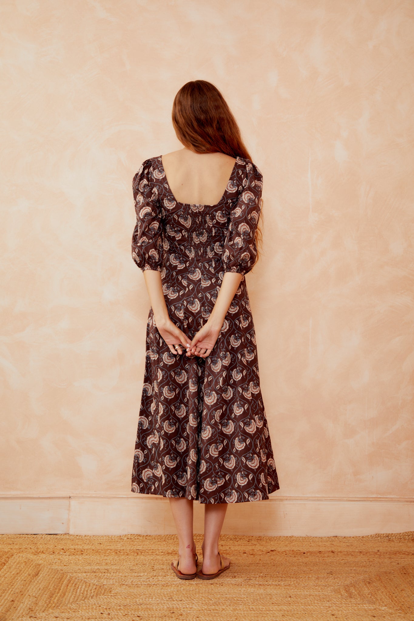 Back of dark coffee paisley midi dress with square back and elbow puff sleeves
