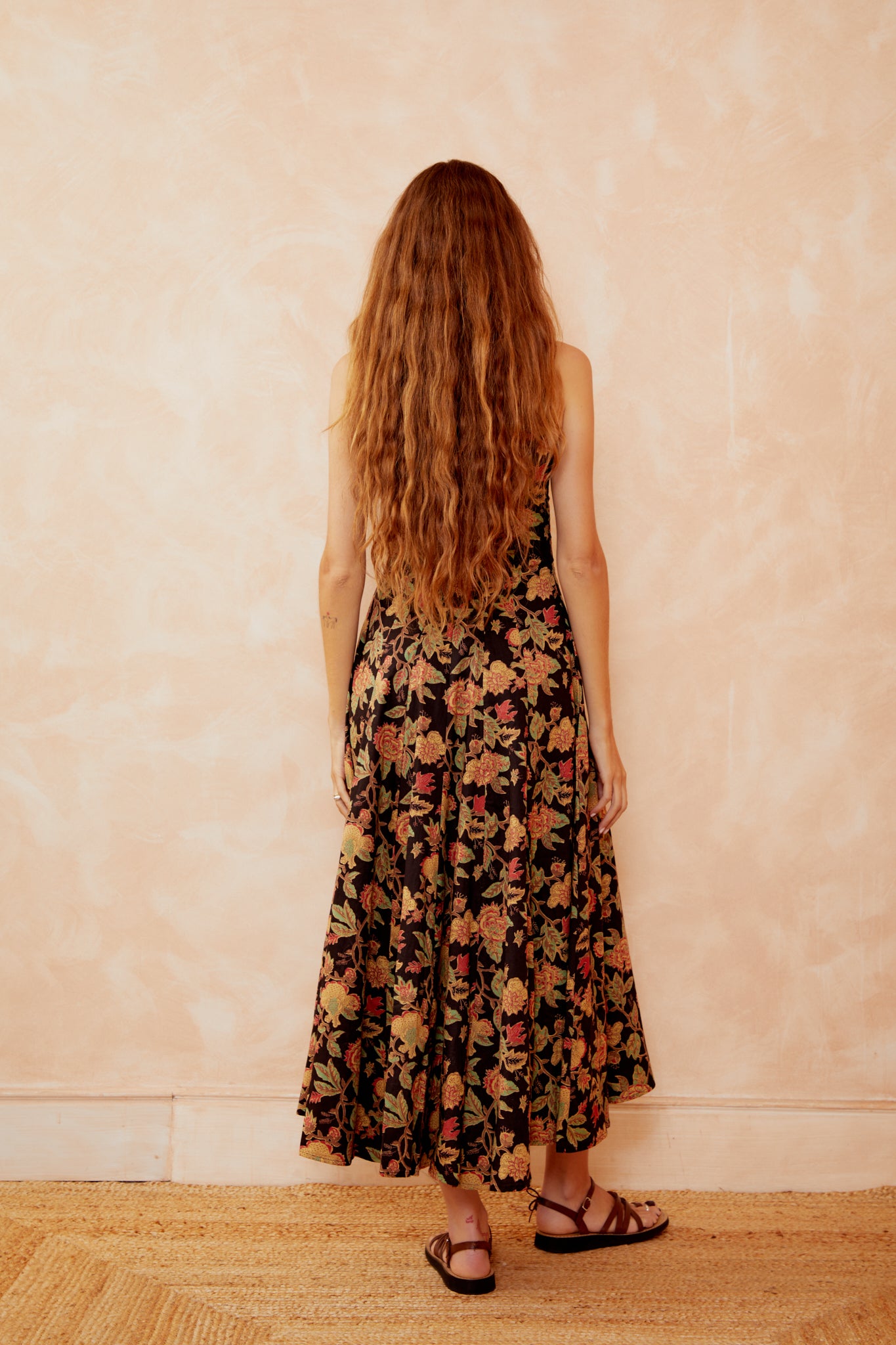 Floral maxi dress back view, sleeveless with wide straps and gathered tiers