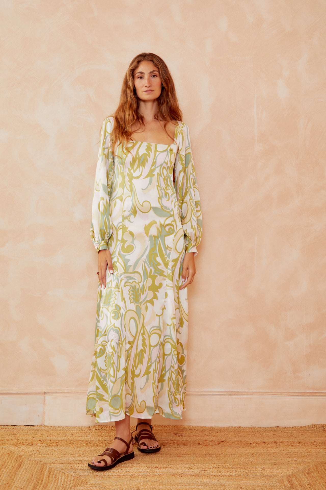 Alegra printed dress on model, cream with yellow-green botanical print, square neckline, puff sleeves