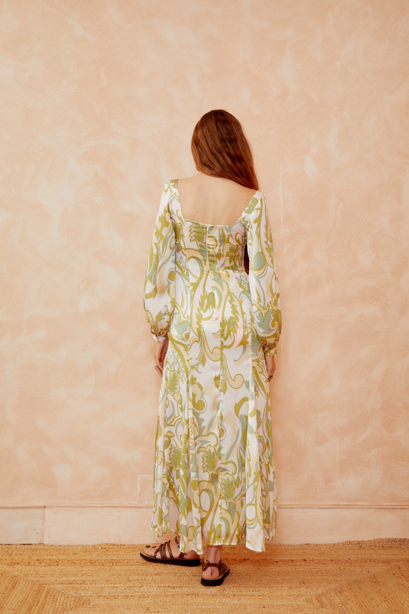 Alegra printed dress back view, cream with yellow-green botanical print, square back, long sleeves