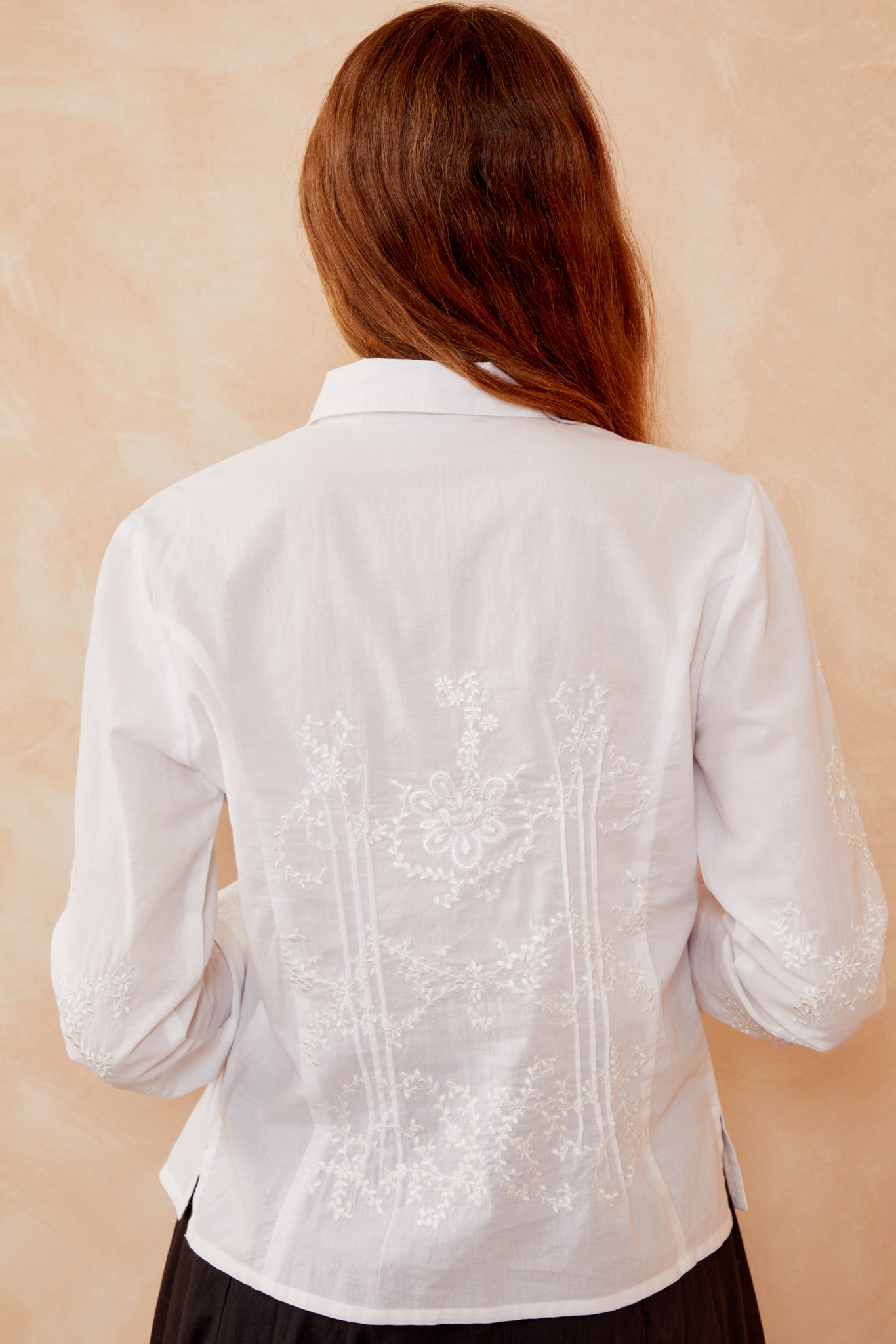 White button-up shirt back view with embroidered floral yoke and panel.