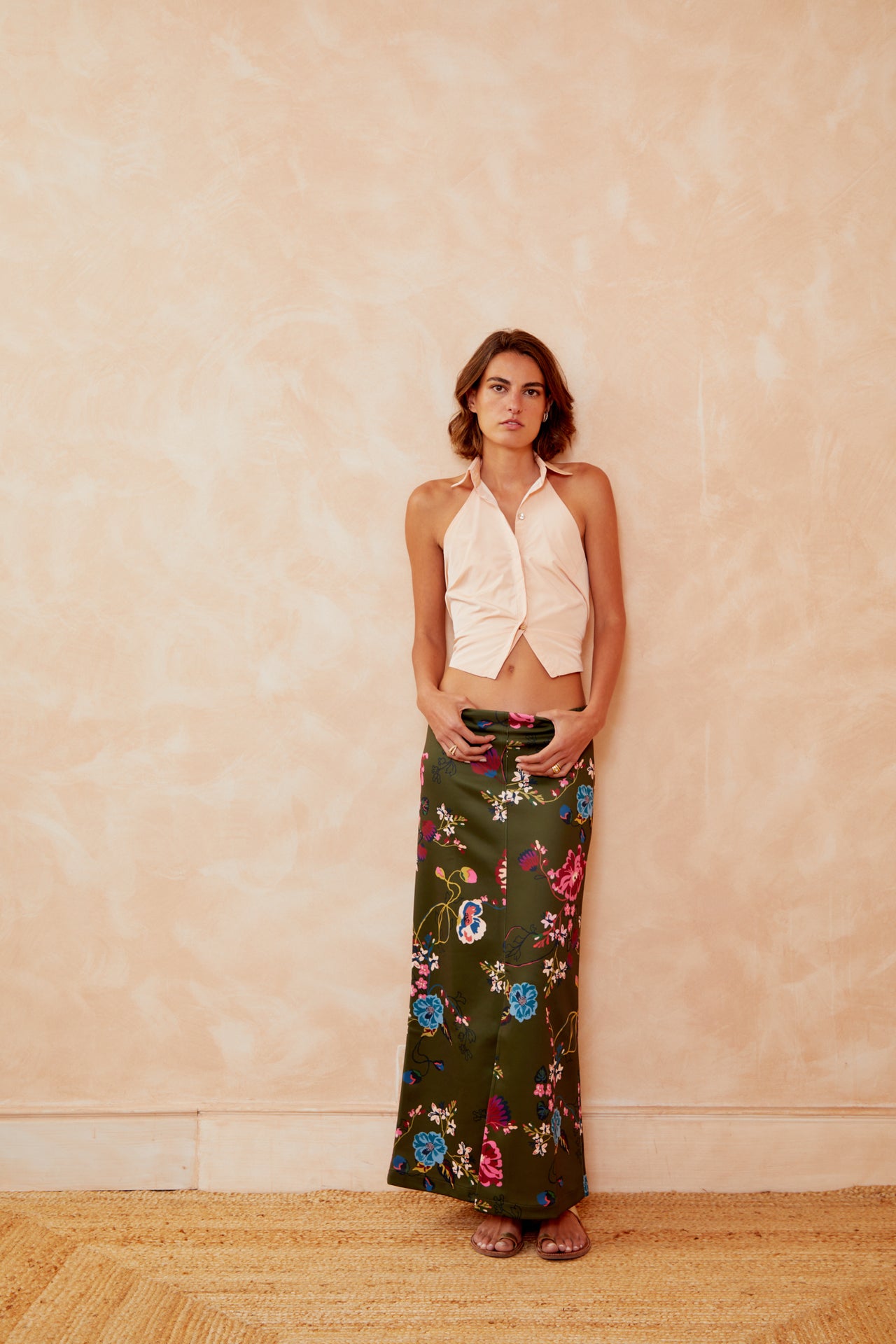 Floral tube skirt in dark green with bright flowers and birds, worn full length
