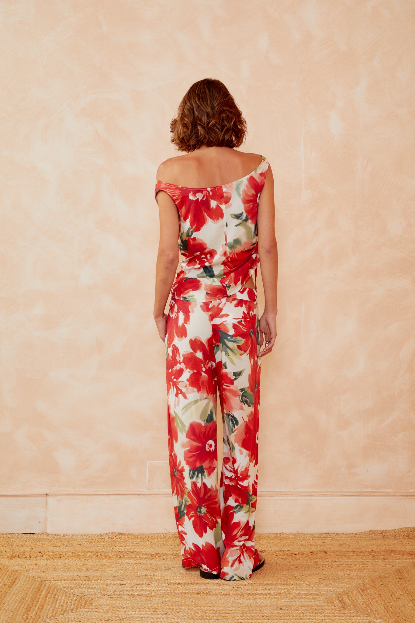 Floral sleeveless top with red and white blooms, open scoop back