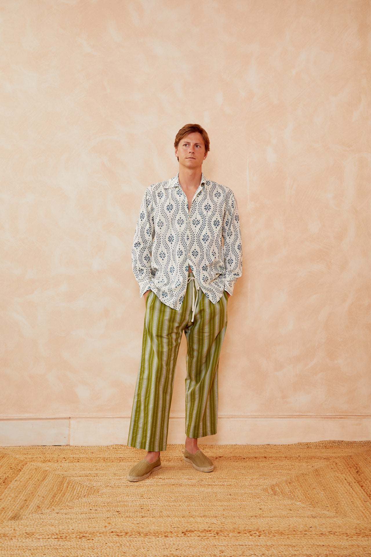 Off-white long-sleeve shirt with blue flower swirl pattern, V-neck and loose cuffs