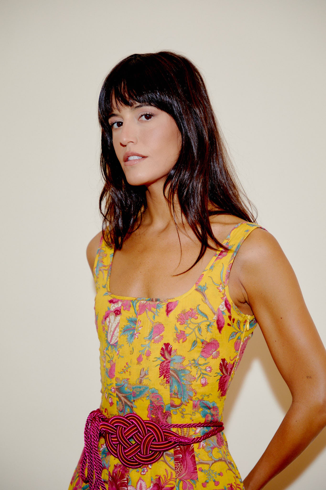 Yellow floral sleeveless dress with square neckline and fuchsia braided waist belt