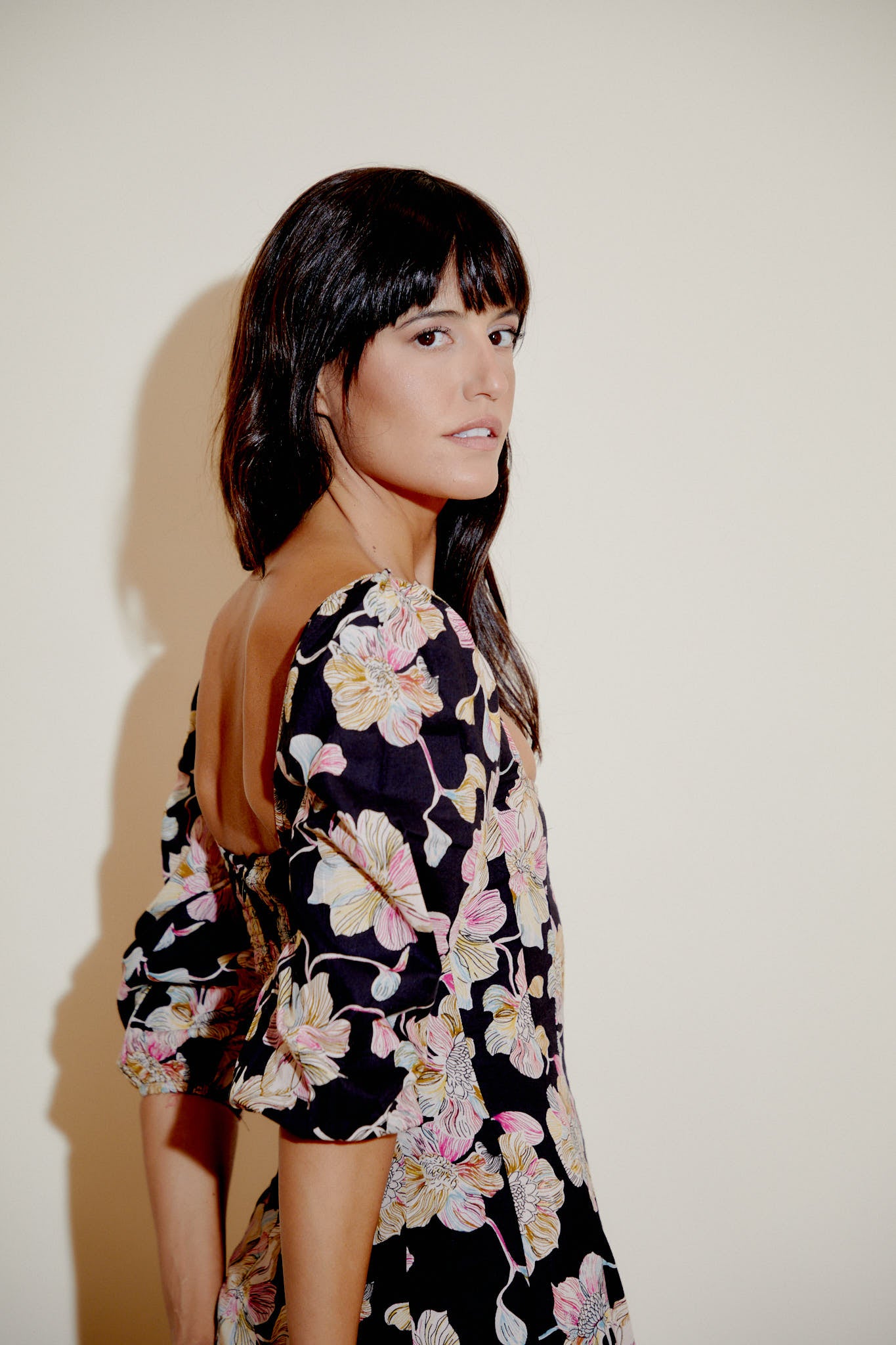 Aurelia dress close-up: black floral print bodice with square neckline and puff sleeves