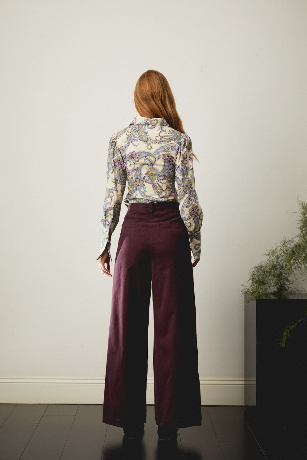 Aubergine wide-leg trousers, full-length back view with side pockets