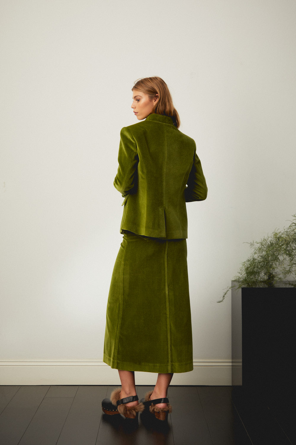 Green suede-style jacket, back view with structured shoulders and button detail