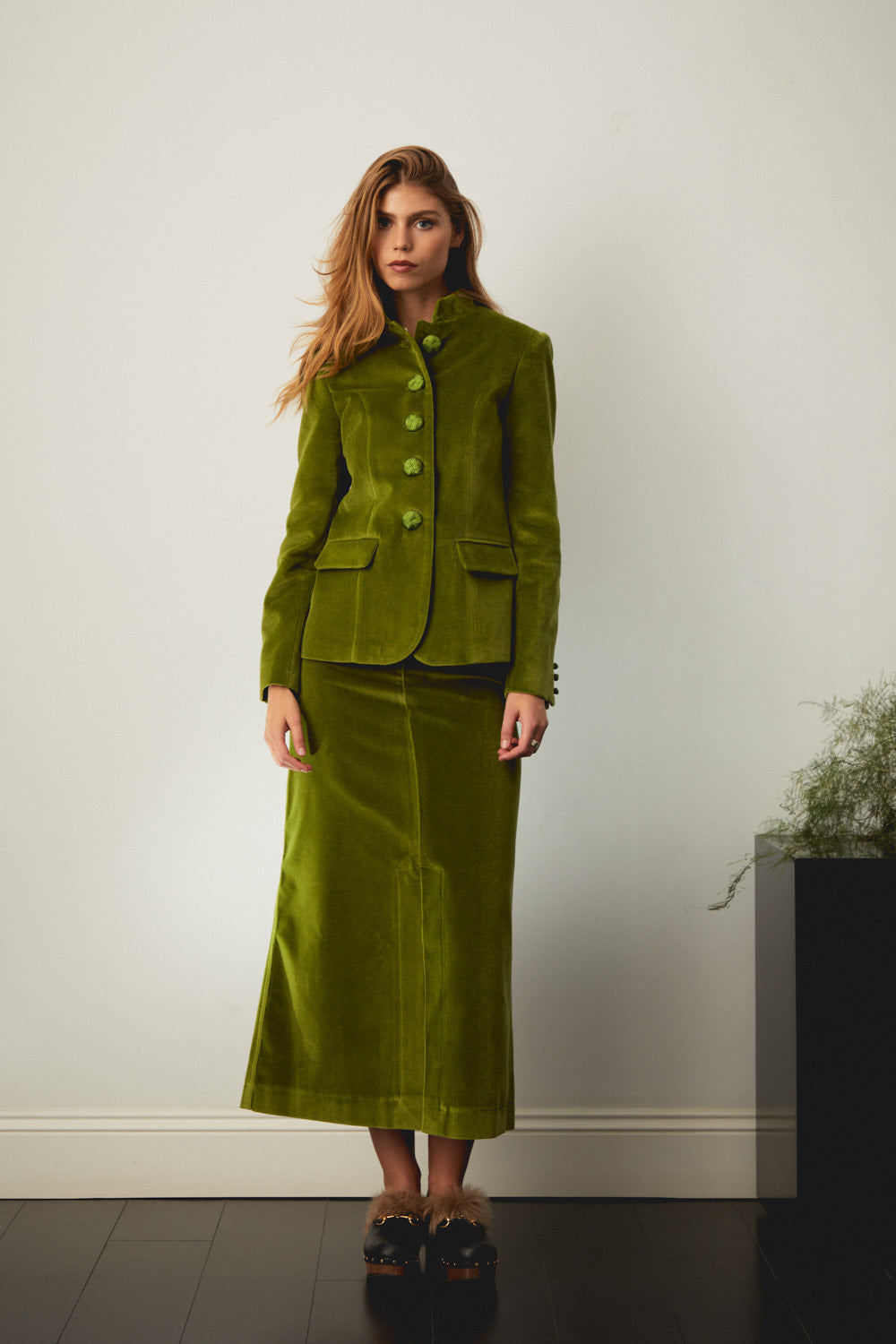 Green suede-style jacket with chest flap pockets and single-breasted button front