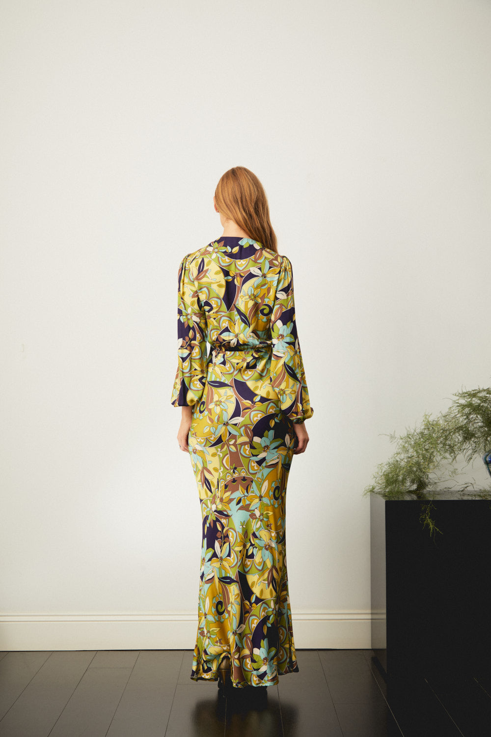 Floral maxi dress with long sleeves, back view in yellow with navy accents