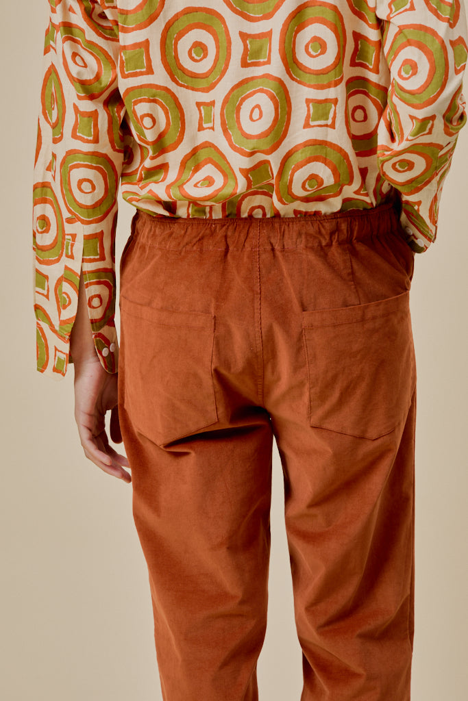 Orange trousers with elastic waistband and deep front pockets