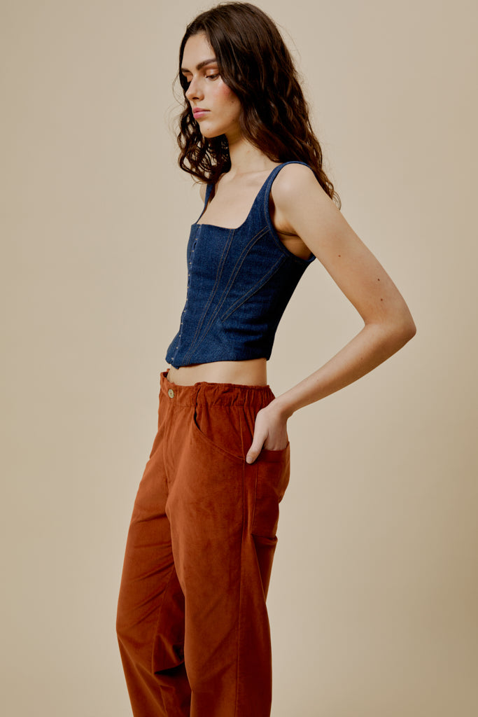 Rust-orange trousers with side pockets, belt loops, and wide straight leg