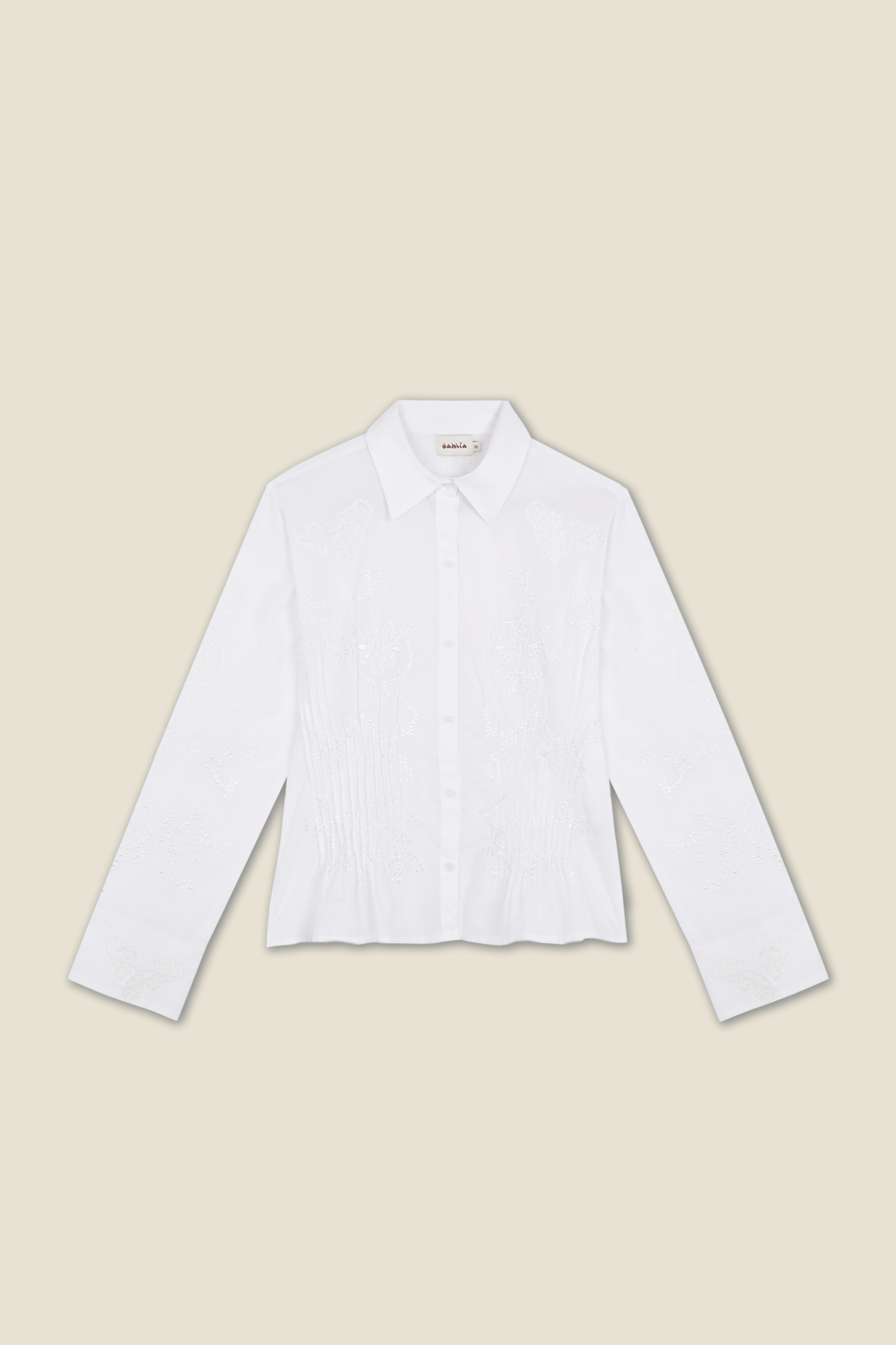 White long-sleeve button-up shirt with embroidered floral panel front.