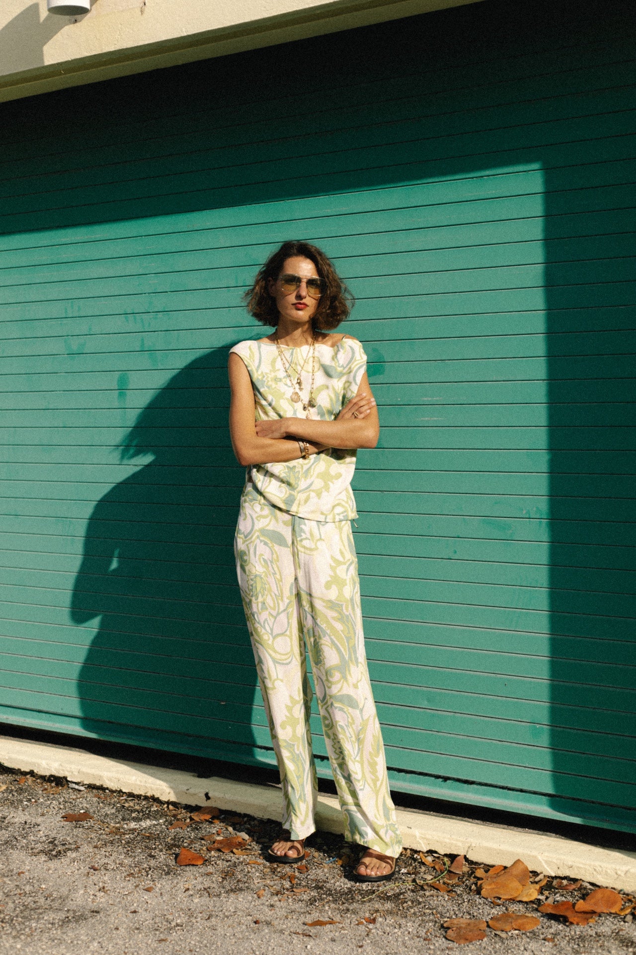 Green Samba trousers with white base and ornate green pattern, wide cropped hem