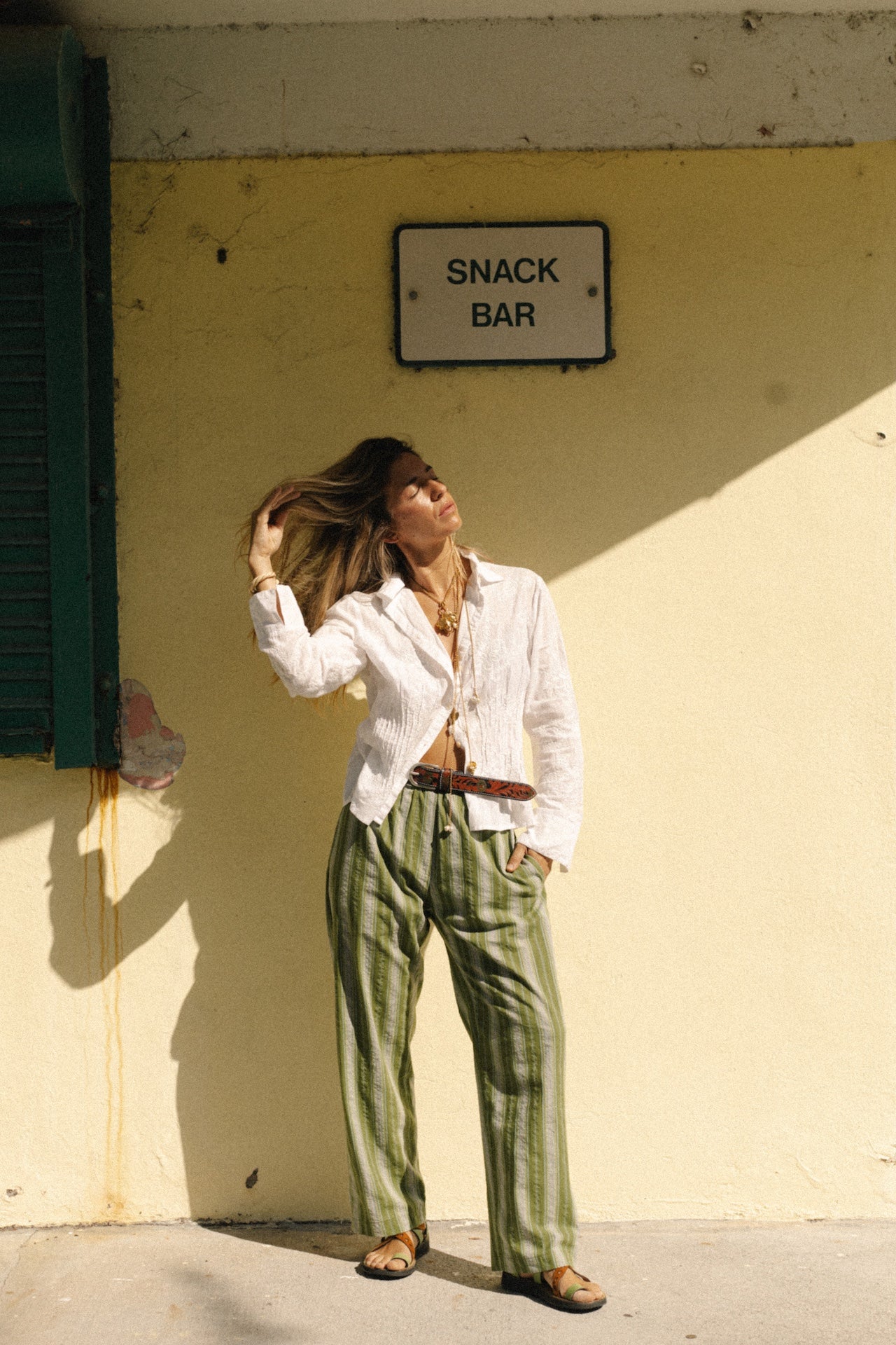 White embroidered long-sleeve button-up shirt with gathered front yoke.