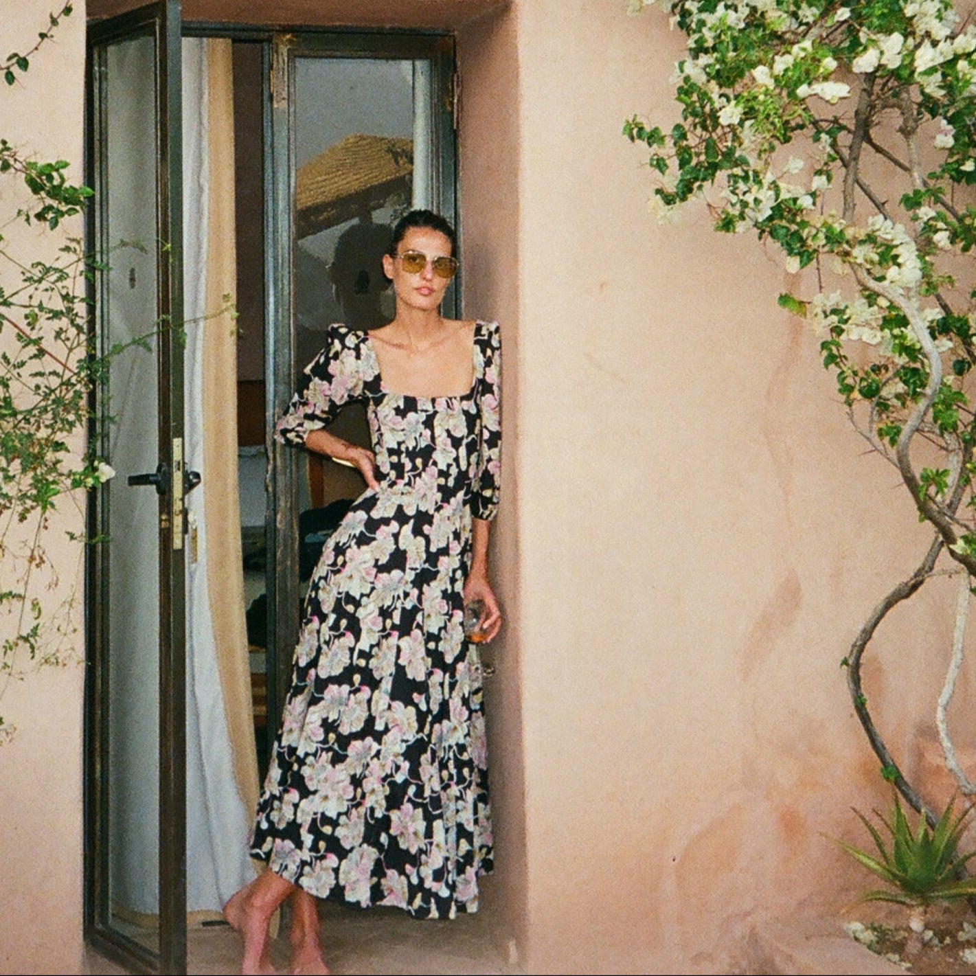 Aurelia dress with black background and pink floral print, square neck and full-length skirt