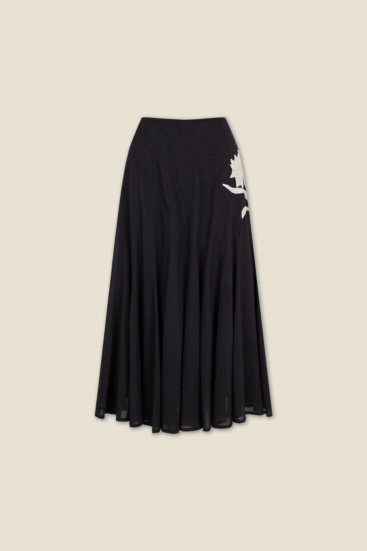 Black pleated midi skirt with large white leaf applique on side