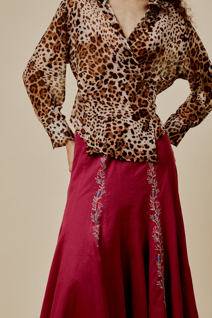 Leopard-print long-sleeve shirt with V-style collar and button front.