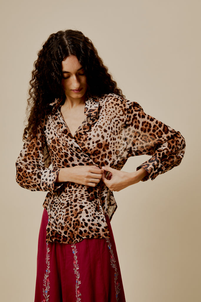 Leopard-print shirt with collared button front and long sleeves, front view.